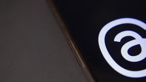 Threads social media app by meta. Threads app icon logo on the phone display. Stock Footage 258929870