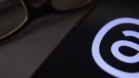 Threads social media app by meta. Threads app icon logo on the phone display. Stock Footage 258930101