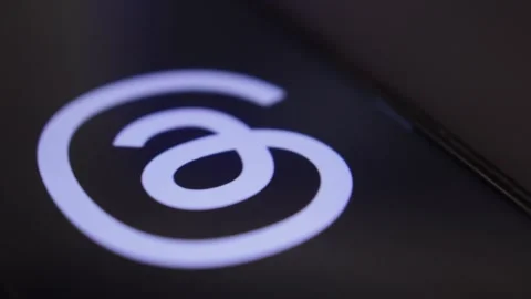 Threads social media app by meta. Threads app icon logo on the phone display. Stock Footage 258930621
