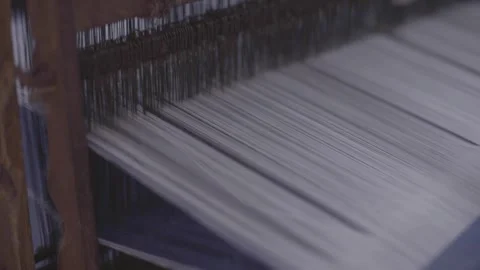 The threads on traditional looms move up and down to form cloth Stock Footage 248799267