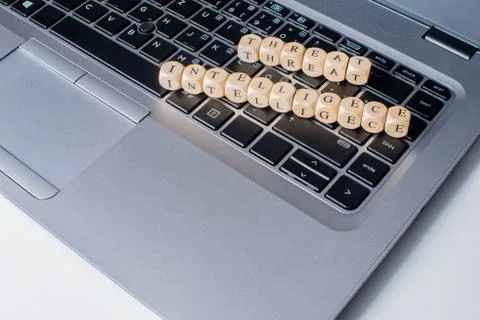 Threat Intelligence word on notebook keyboard Stock Photos