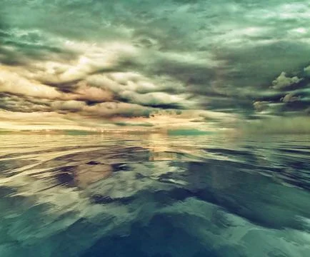 Threatening storm clouds over calm water Stock Photos