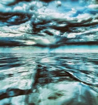 Threatening storm clouds over a cold blue sea Stock Photos