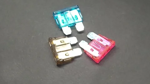 Three 12v blade fuses revolve in front of camera Stock Footage 245000719