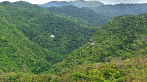 Three (3) Helicopters flying over the Mountain Ranges of Palawan Philippines Video stock 25713897