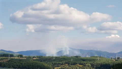 Three active fires are emitting columns of smoke in the mountains of El Bierzo Stock Footage 315531951