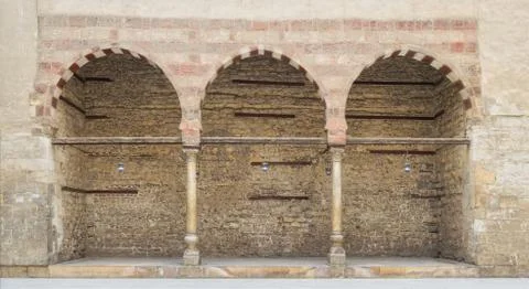 Three adjacent arches on stone wall Stock Photos