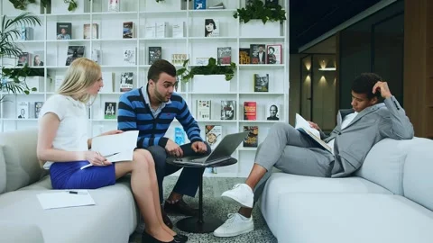 Three Adults Collaborating with Laptop in Modern Warsaw Office Stock Footage 340265584