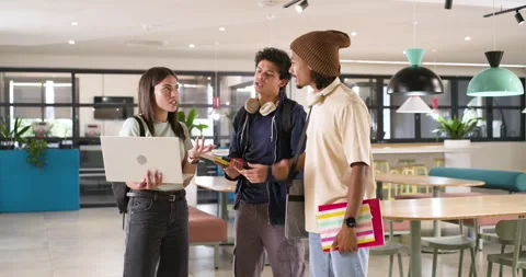 Three African American students drawn to campus hub by woman holding laptop men Stock Footage 344253852