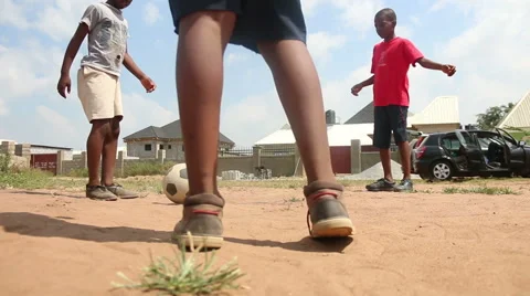 Three African Black Boys in a triangle play football low angle Vídeos de archivo 57865295