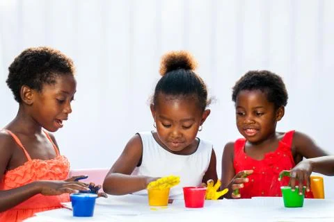 Three african kids painting with hands. Stock Photos