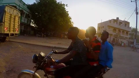 Three African Men on a Motorcycle in Slow Motion Video stock 79019898