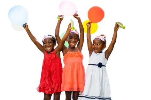 Three african youngsters having fun with balloons at party. Stock Photos