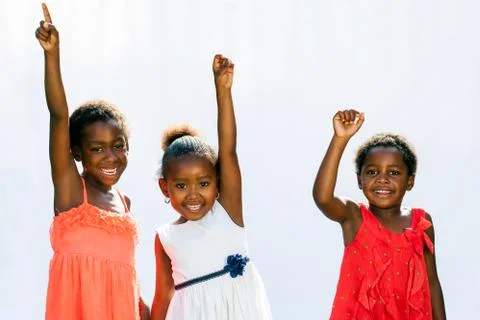 Three african youngsters raising hands. Stock Photos
