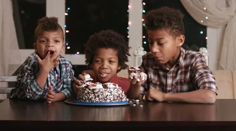 Three afro boys eating cake. Video stock 61746738
