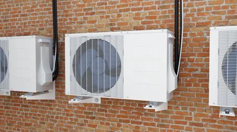 Three air conditioners on a brick wall 3d Illustrazione stock