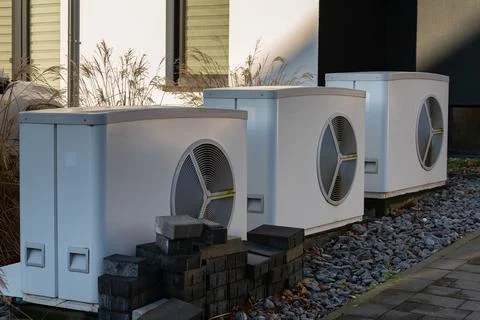 Three air conditioning units installed beside a modern building Stock Photos