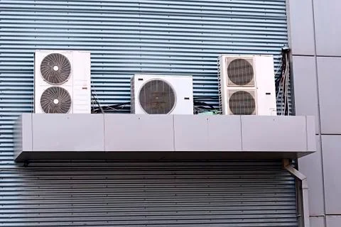 Three air conditioning units on the outside wall of. Stock Photos