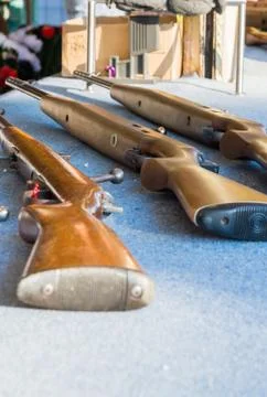 Three Air Rifles Laying Table Fair Game Blue Texture Stock-Fotos