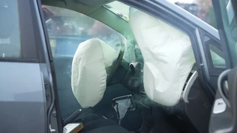Three airbags exploding in a still standing car in slowmotion Stock Footage 168217355