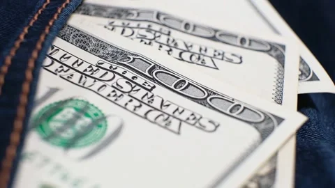 Three American Banknotes of 100 Dollars in a jeans pocket on rotating table. Stock Footage 142437822