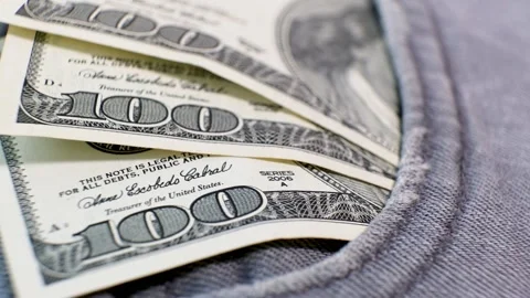 Three American Banknotes of 100 Dollars in a jeans pocket on rotating table. Stock Footage 142515843