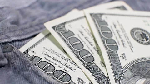Three American Banknotes of 100 Dollars in a jeans pocket on rotating table. Stock Footage 142582405