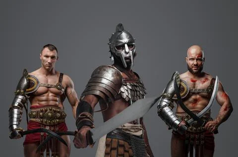 Three ancient gladiators with light armors and swords 库存照片