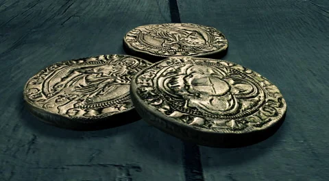Three Ancient Gold Coins Sitting Atop A Wooden Table. Stock Footage