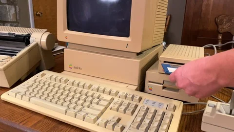 Three and half inch floppy disc inserted into Apple 2GS disk drive, Stock Footage 123646611