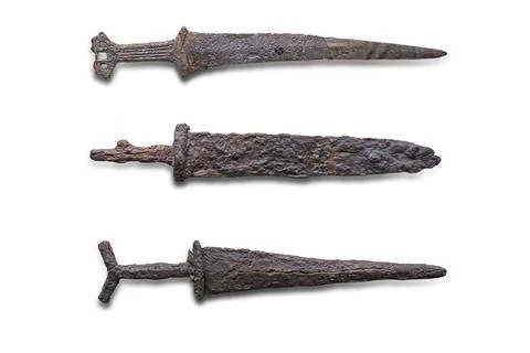 Three antique objects in a line against a gray backdrop Includes an aged key, Foto stock