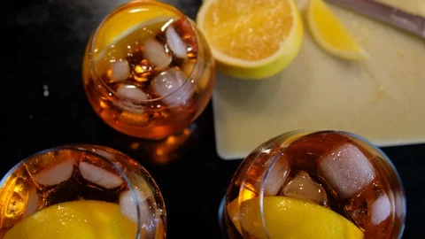 Three aperol spritz drinks with orange in the background. Stock Footage 93895315