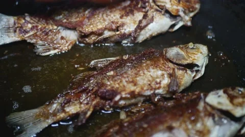 Three appetizing fish fry in a frying pan Vídeos de archivo 224886249