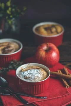 Three apple pies in ceramic baking molds with red napkin ramekin on dark wood Stock Photos