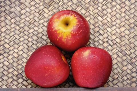 Three apples on bamboo Stock Photos
