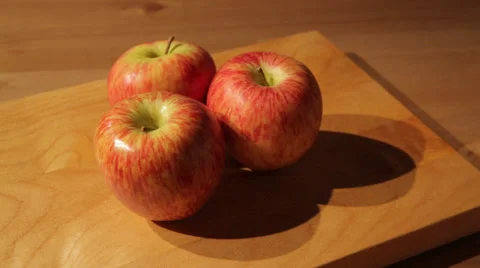 Three apples on a cutting board Stock Footage 52088676