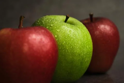 Three apples on a dark background Stock Photos
