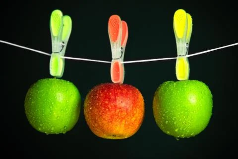 Three apples in a row on black background Stock Photos