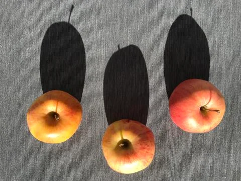 Three apples on the table Stock Photos