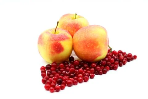 Three apples on a white background and berry cranberries Stock Photos
