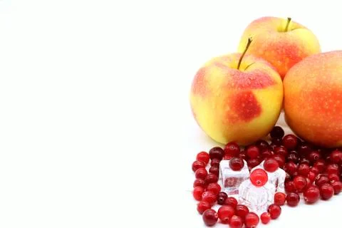 Three apples on a white background with ice cubes and cranberry berry 스톡 사진