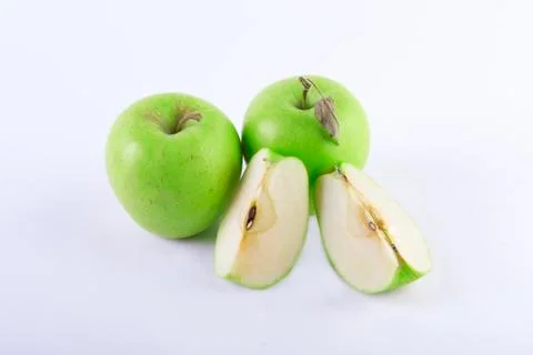 Three apples on a white background. A sliced apple on a white background. Com Stock Photos