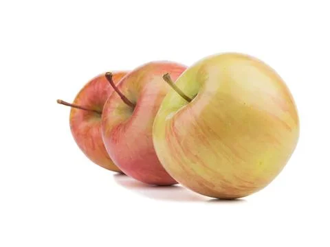 Three apples with yellow and red skin on white background Stock Photos