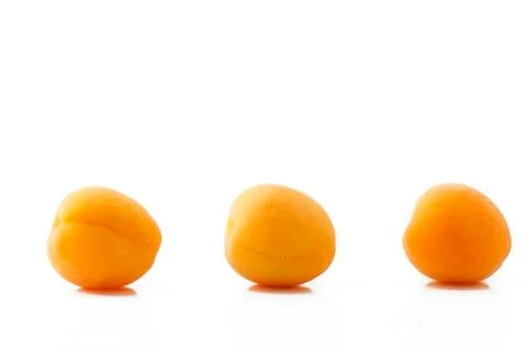 Three apricots in a row Stock Photos