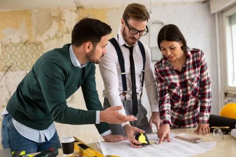 Three  architects checking blueprint Stock Photos