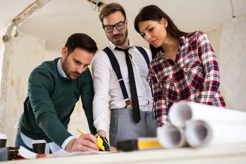 Three  architects checking blueprint Stock Photos