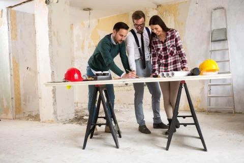Three  architects checking blueprint Foto stock
