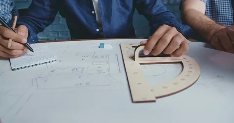 Three architectures working on a building plan. Young specialists collaborating 스톡 동영상 107750878