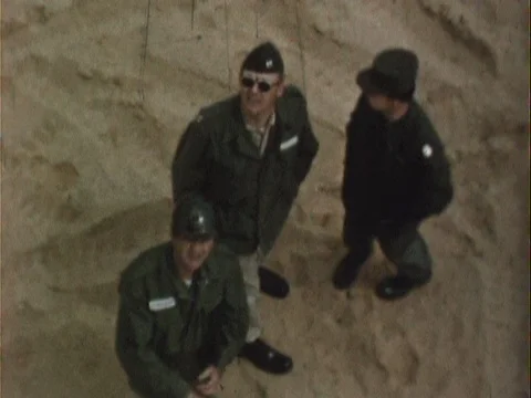 Three army generals looking up on a beach - vintage 8mm Stock Footage 78932766