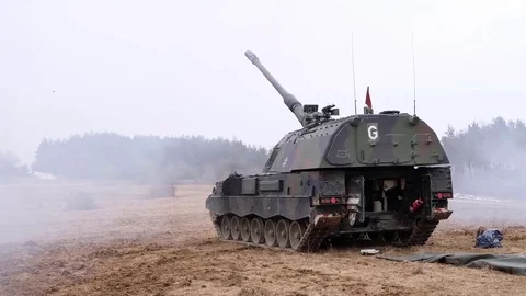 Three artillery mounts shoot in the field. NATO exercises Stock Footage 121796221